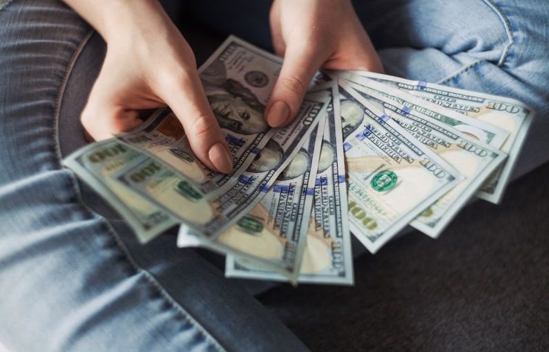 Financial Independence - fan of 100 U.S. dollar banknotes