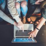 Customer Retention - three person pointing the silver laptop computer