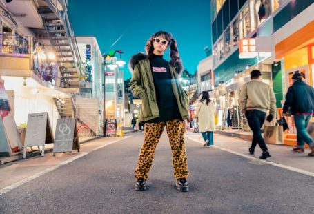 Trends - woman in green jacket stands and pose on street