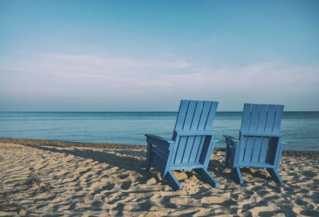 Retirement Planning - two blue beach chairs near body of water