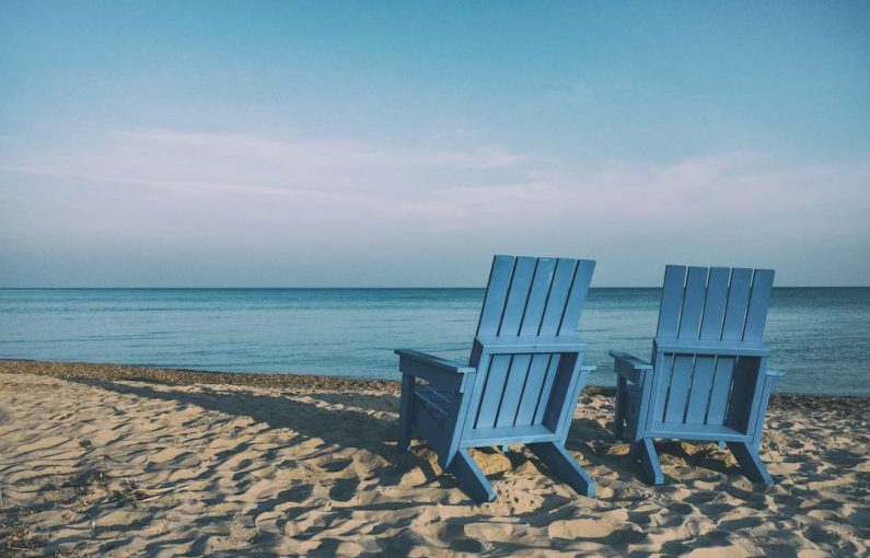 Retirement Planning - two blue beach chairs near body of water