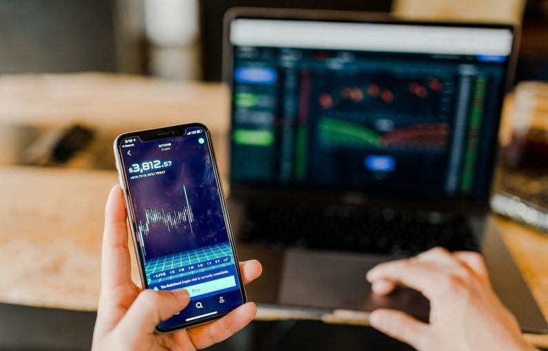 Income Streams - person using phone and laptop computer