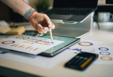 Tax Impact - a person is writing on a piece of paper