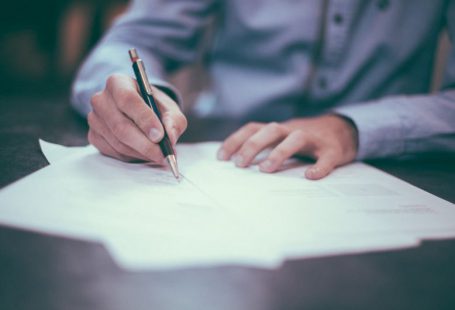 Insurance Policy - man writing on paper