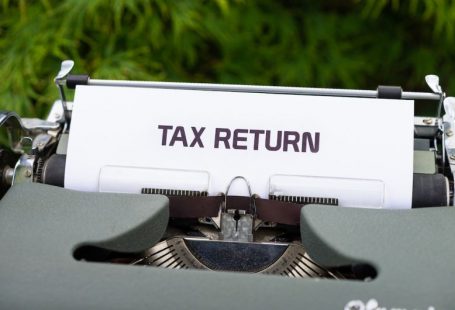 Tax Refund - a close up of a typewriter with a tax return sign on it