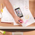 Financial Goals - person writing on white paper