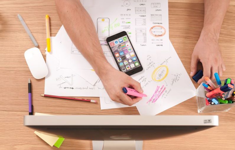 Financial Goals - person writing on white paper