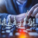 Strategy Chess - depth of field photography of man playing chess