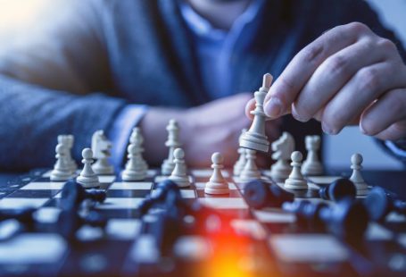 Strategy Chess - depth of field photography of man playing chess