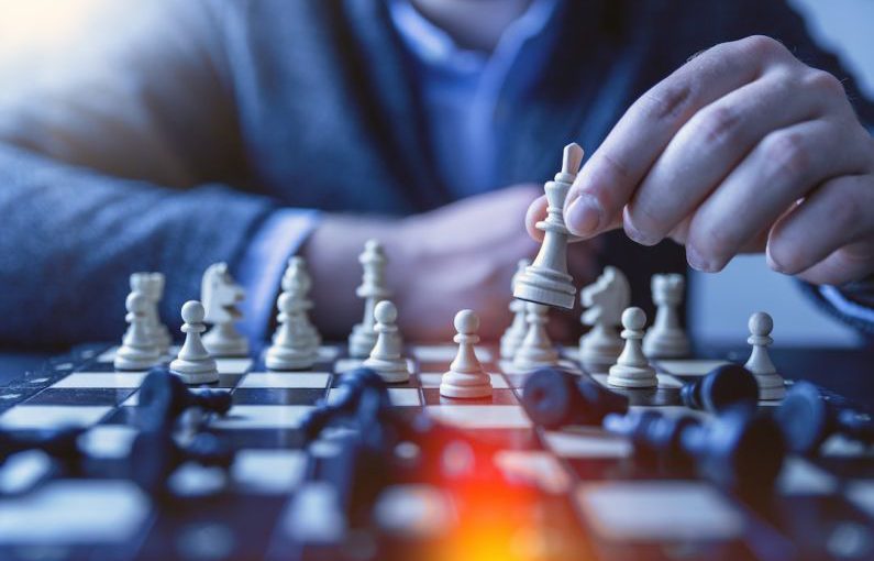 Strategy Chess - depth of field photography of man playing chess