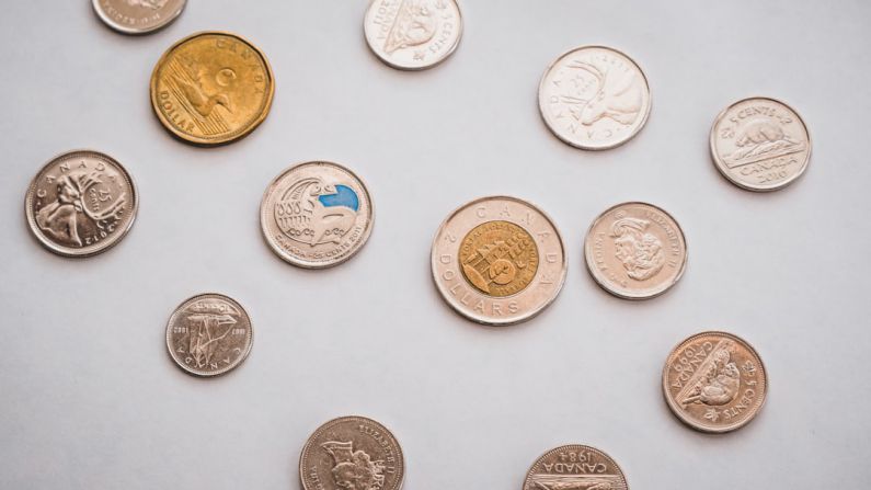 Debt Scale - a bunch of different types of coins on a table