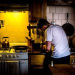 Socially Responsible - man standing beside range oven
