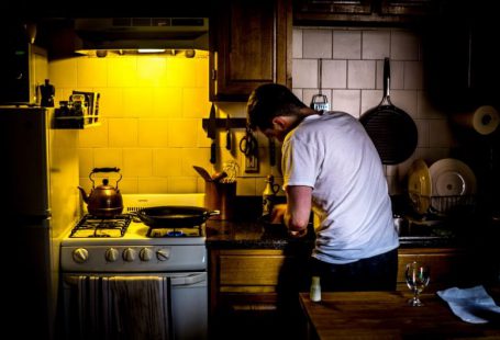 Socially Responsible - man standing beside range oven