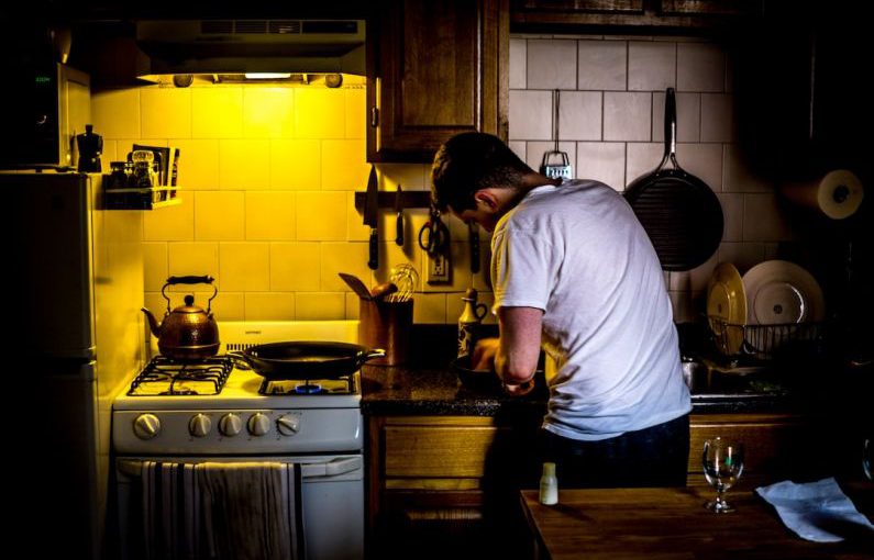 Socially Responsible - man standing beside range oven