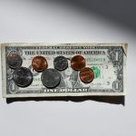 Debt Reduction - silver and gold round coins in box