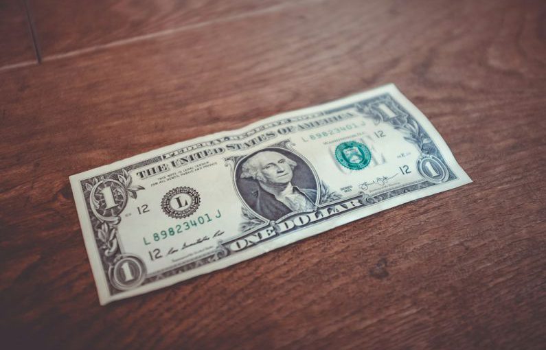 Compound Interest - 1 US dollar banknote close-up photography