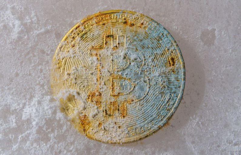 Market Volatility - a dirty round object sitting on a white surface