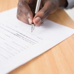 Legal Documents - person writing on white paper