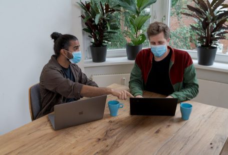 Funding Presentation - man and woman sitting at table using macbook