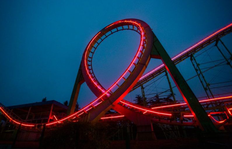 Feedback Loop - a roller coaster lit up at night with red lights