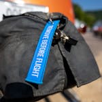 Bright blue 'remove before flight' tag on vehicle exhaust cover.