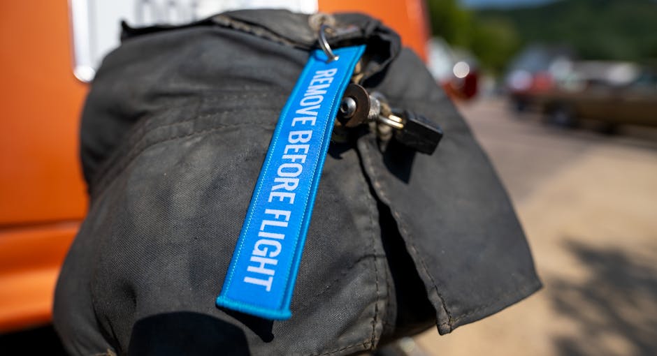 Bright blue 'remove before flight' tag on vehicle exhaust cover.